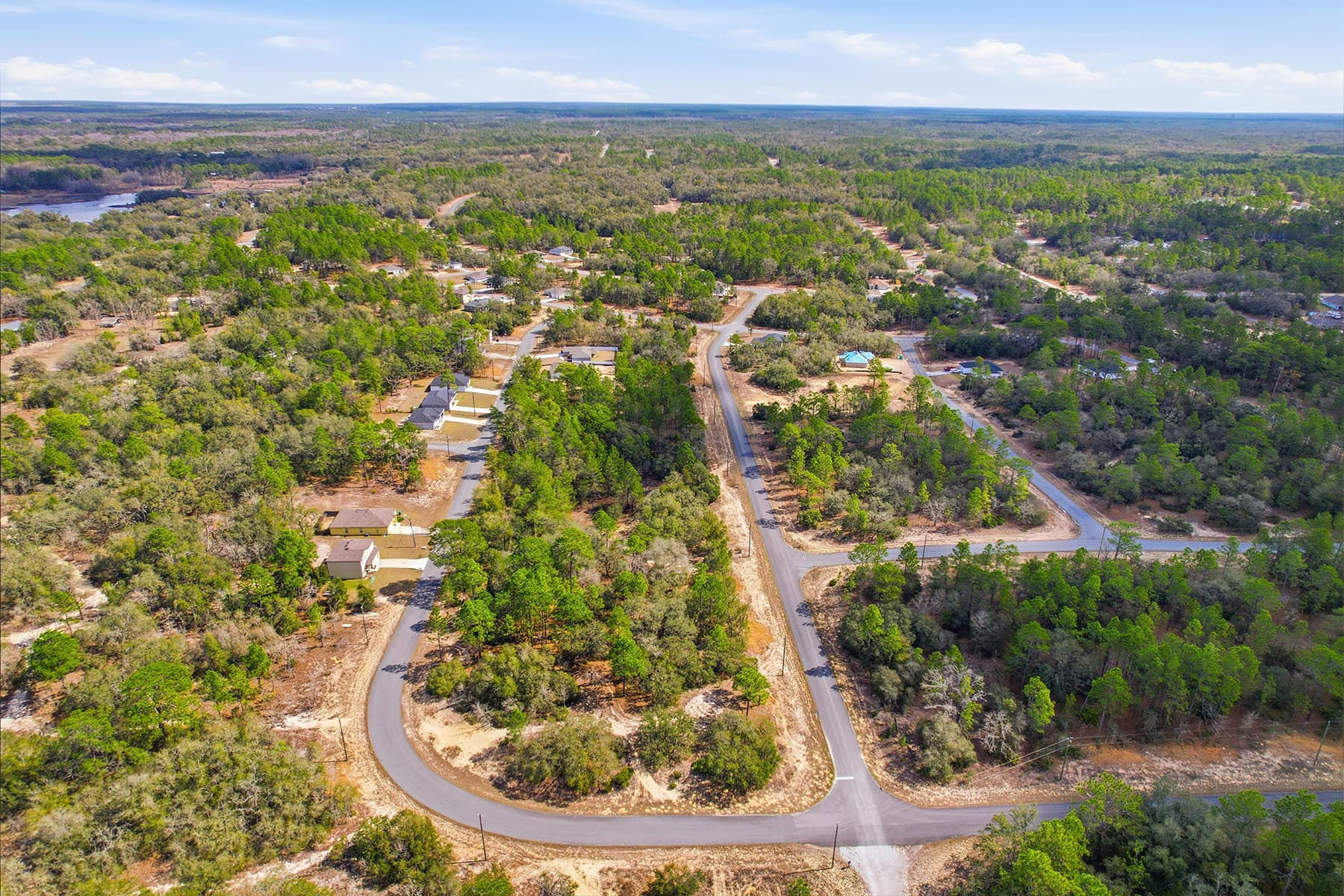 Aerial view of vacant land with roads and natural landscape